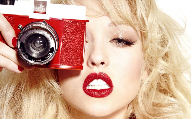 Woman with Red Camera — Confident
