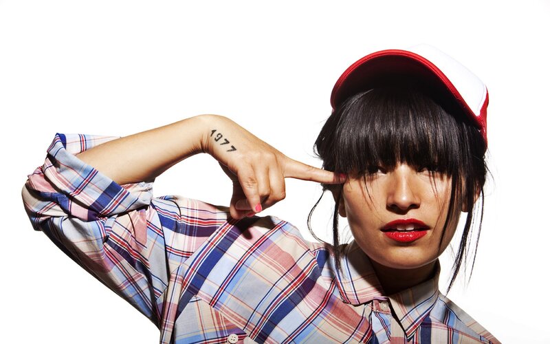 woman with red cap and plaid shirt