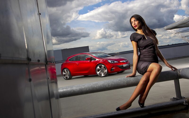 Woman with red car on rooftop