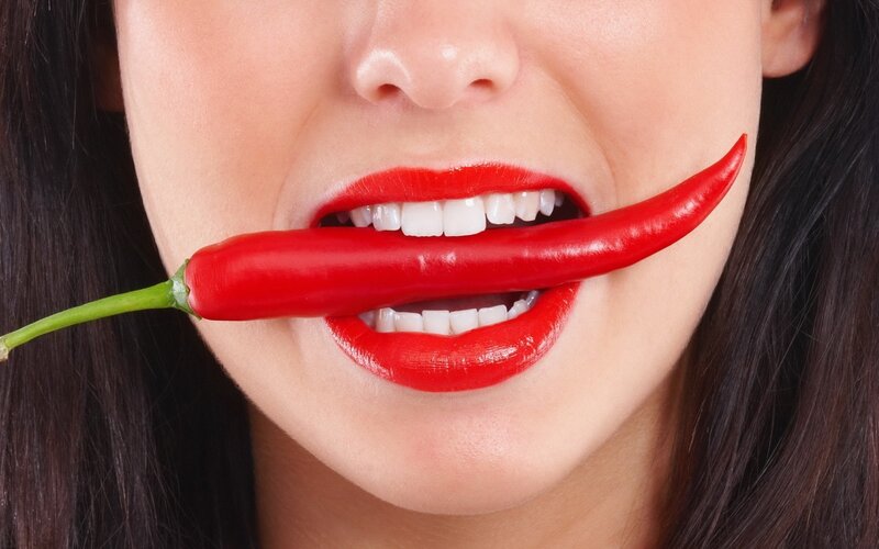 woman with red chili pepper