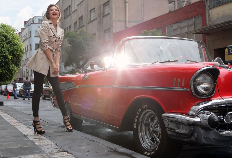 Woman with red classic car