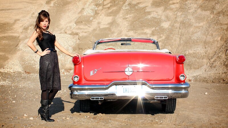 Woman with red classic car