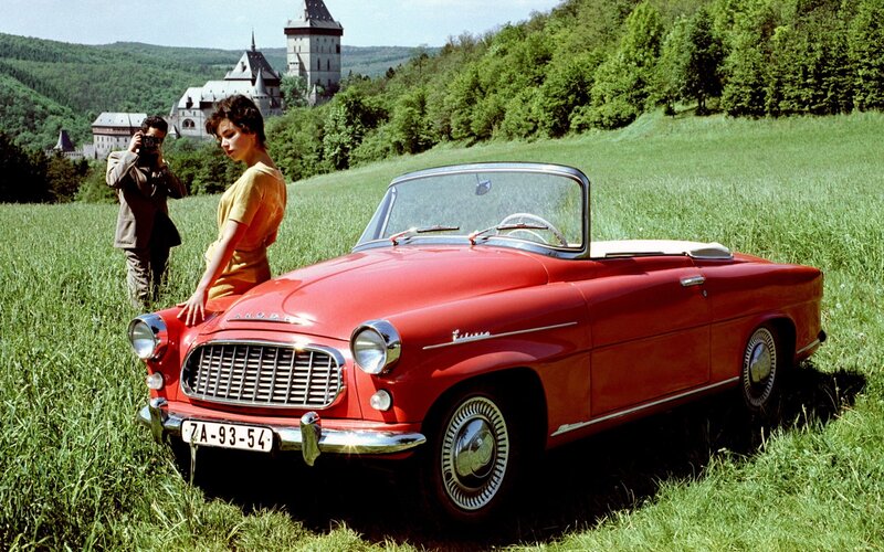 Woman with red convertible car