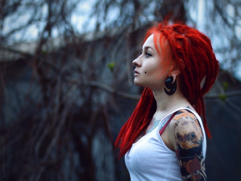 woman with red dreadlocks and tattoos