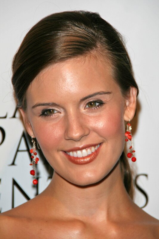 woman with red earrings smiling