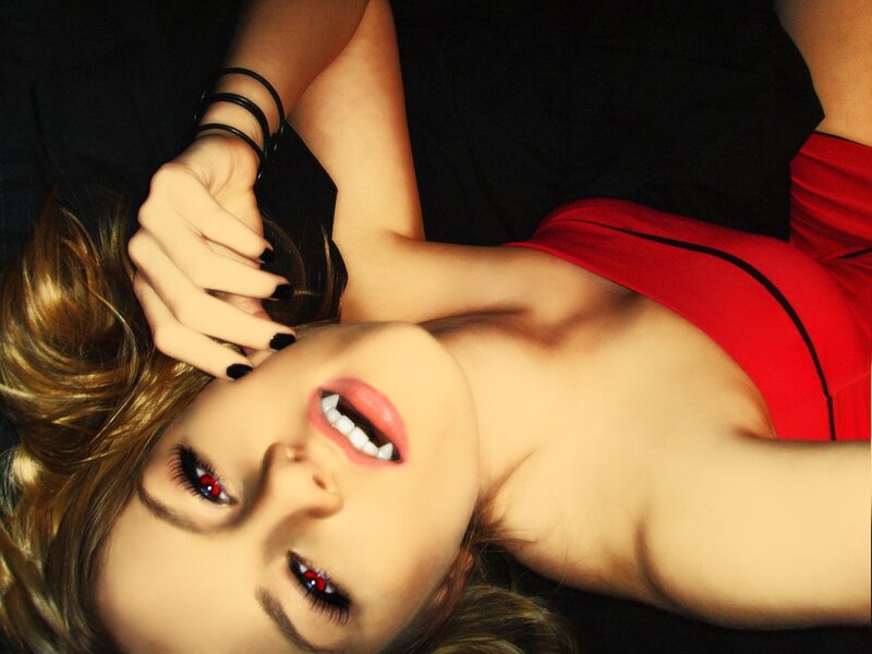 woman with red eyes and fangs