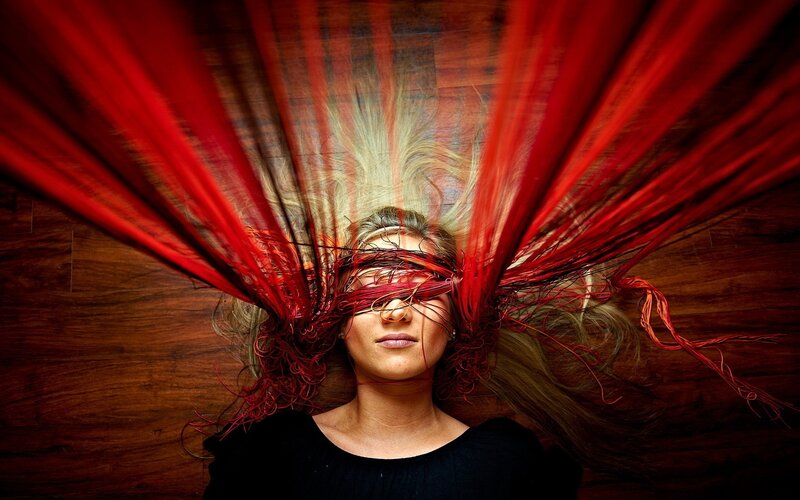 woman with red fabric over face