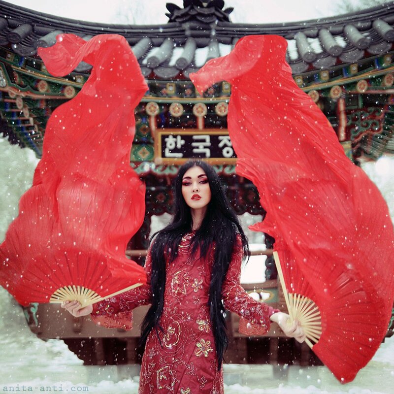 Woman with red fans in snow