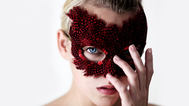 woman with red feather mask