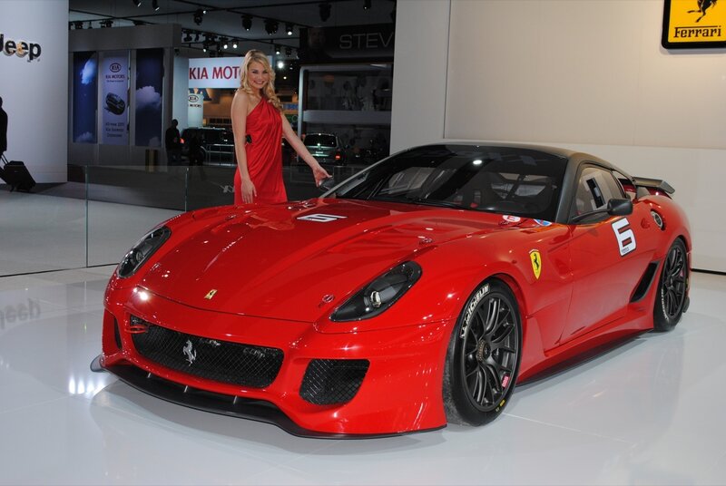 Woman with red Ferrari at auto show