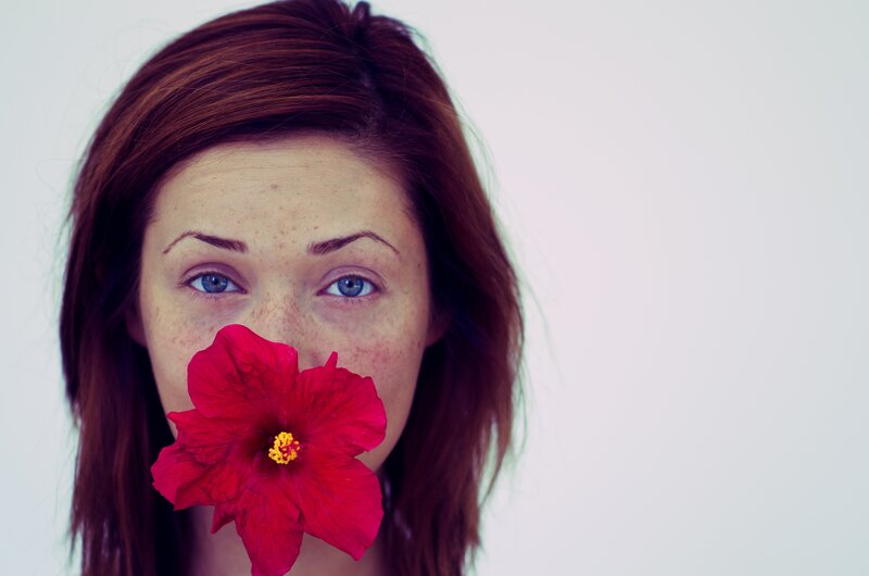 woman with red flower