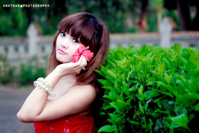 woman with red flower