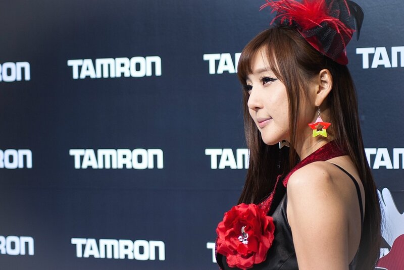 woman with red flower at event