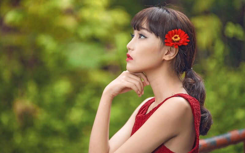 Woman with Red Flower — Contemplative