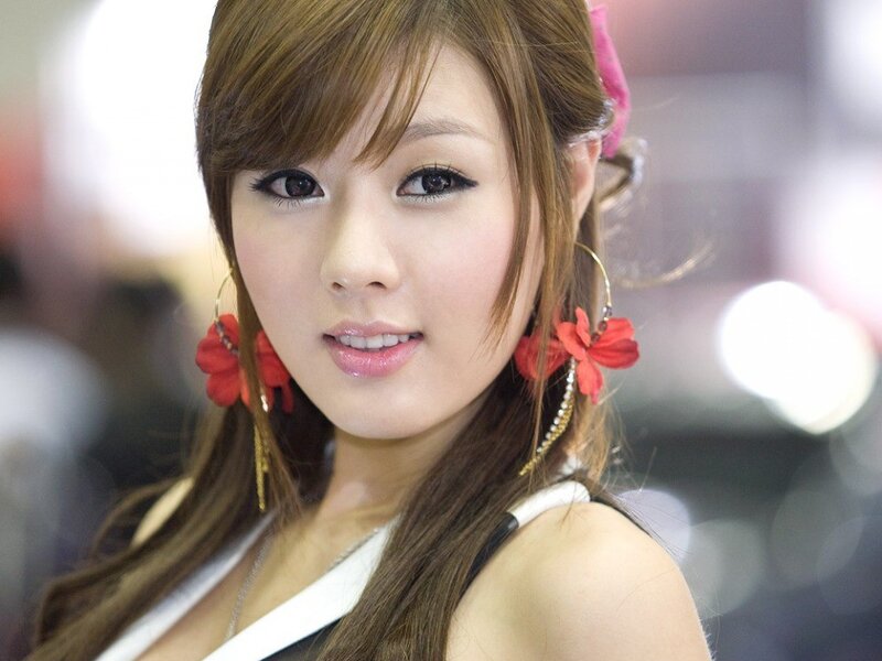 woman with red flower earrings