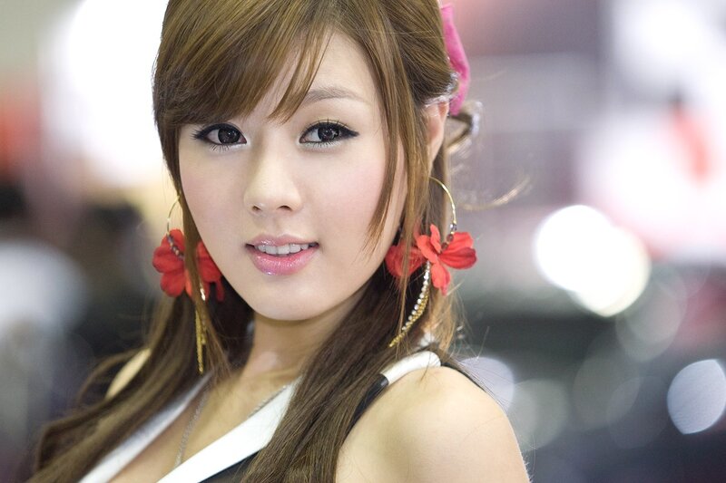 woman with red flower earrings