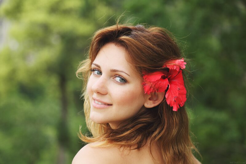 woman with red flower in hair