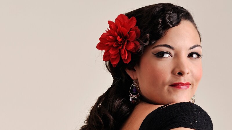 woman with red flower in hair