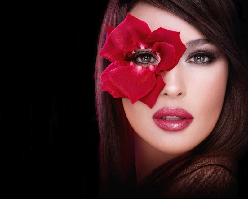 woman with red flower over eye
