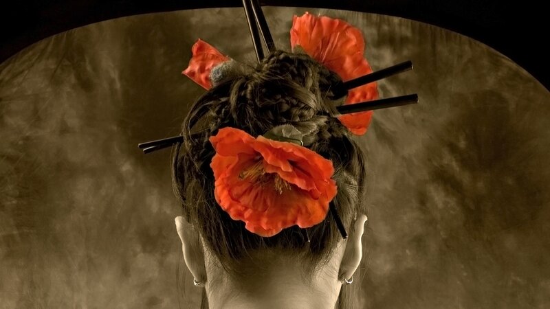 woman with red flowers in hair