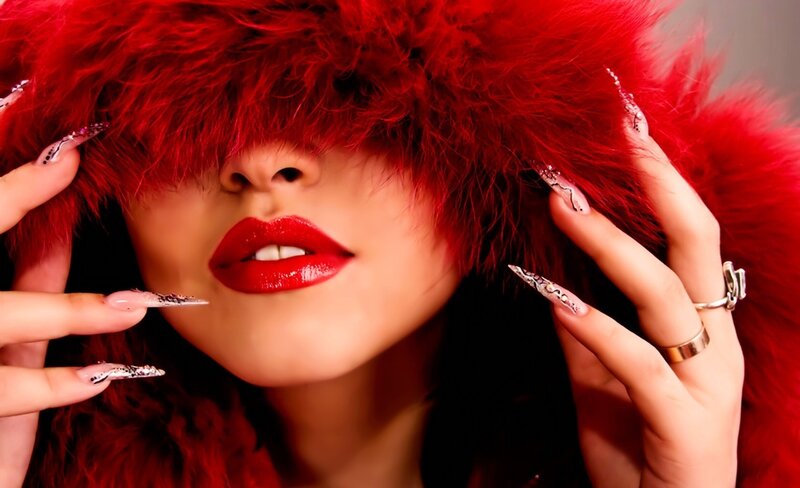 woman with red fur hat and nails