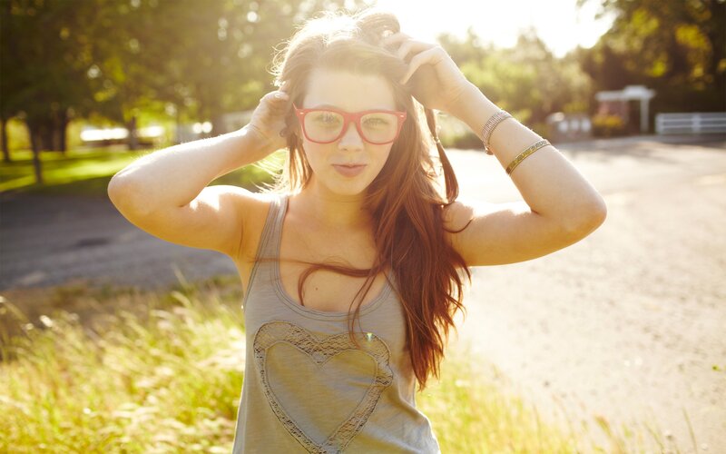 woman with red glasses outdoors