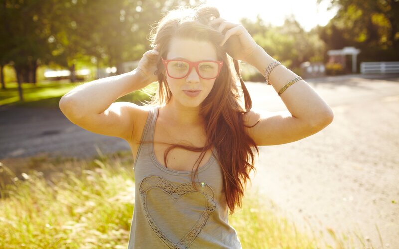 woman with red glasses outdoors