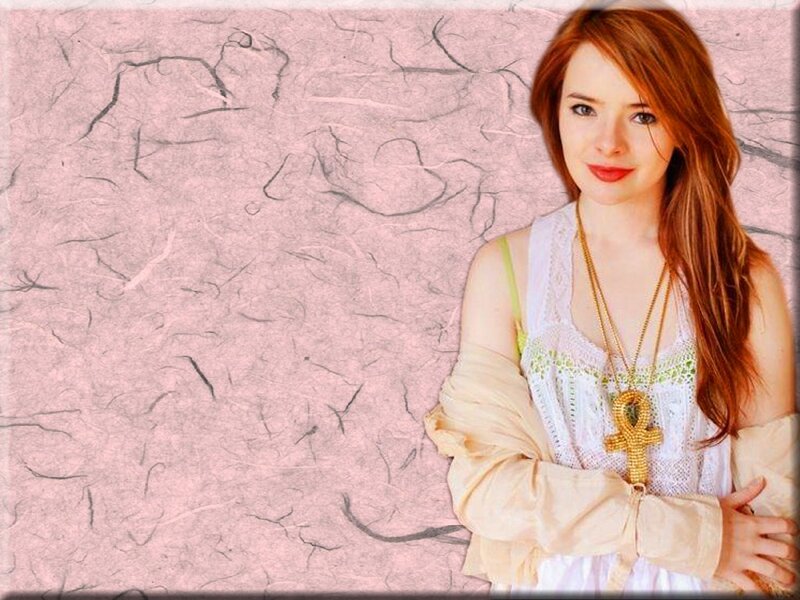 woman with red hair and ankh necklace