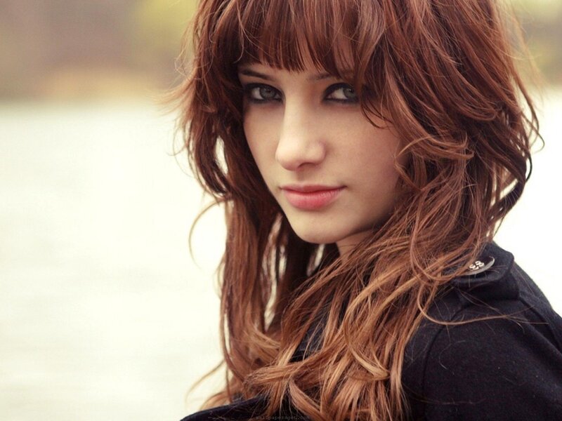 woman with red hair and bangs