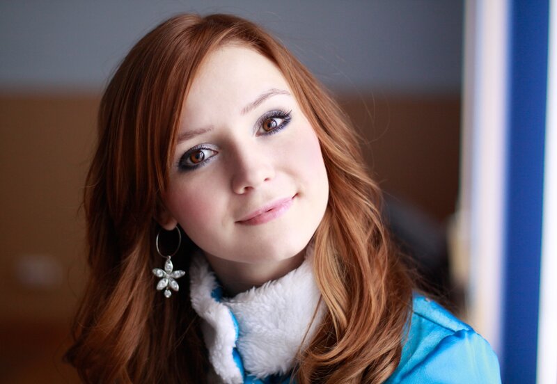 woman with red hair and blue jacket