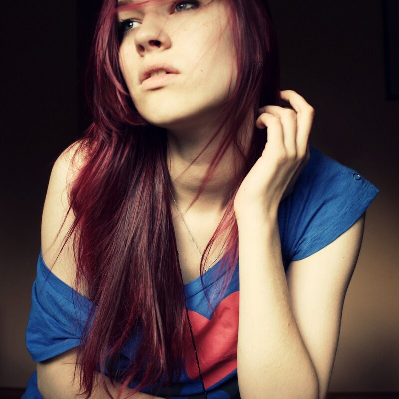 woman with red hair and blue shirt