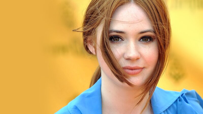 woman with red hair and blue shirt