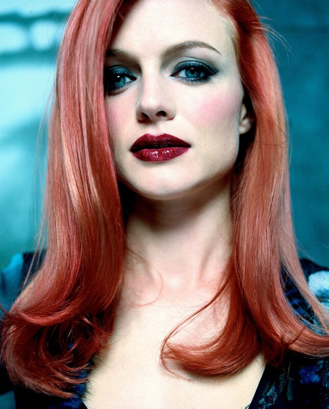 woman with red hair and bold makeup