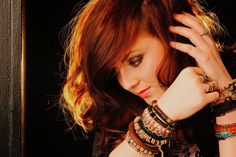 woman with red hair and bracelets