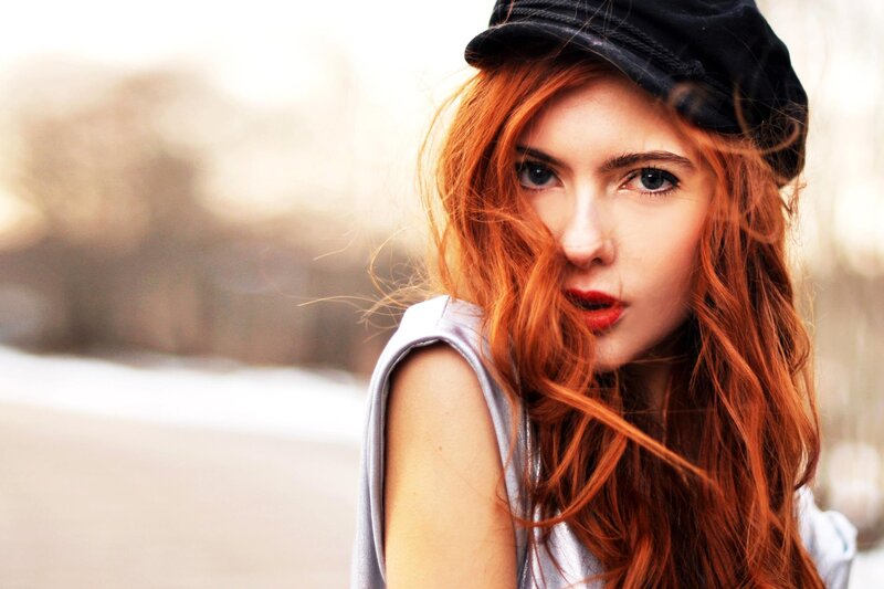 woman with red hair and cap