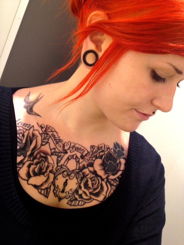 woman with red hair and chest tattoo