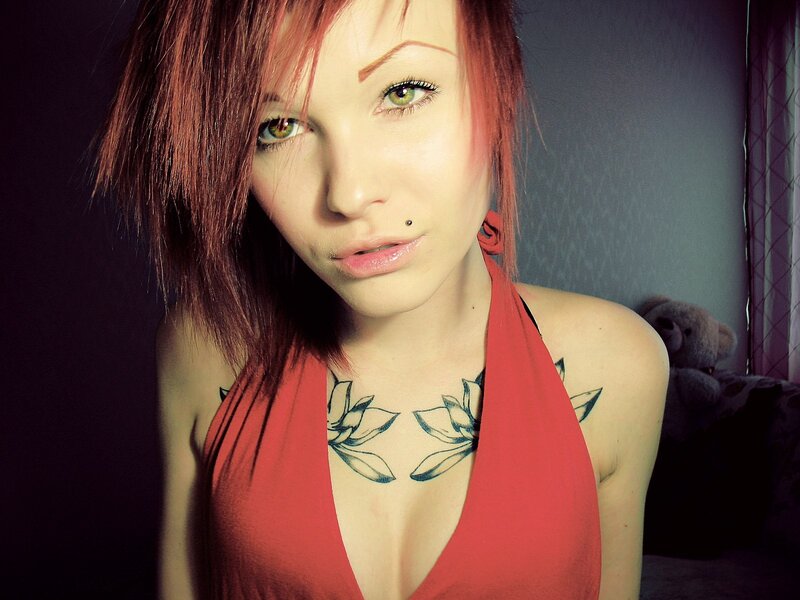 woman with red hair and chest tattoo