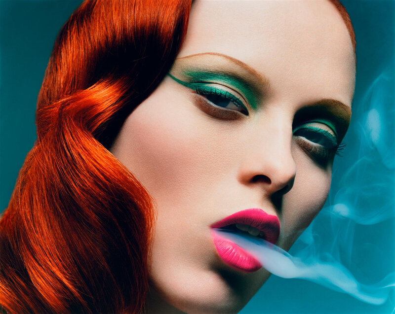woman with red hair and colorful makeup