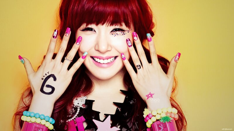 woman with red hair and colorful nails
