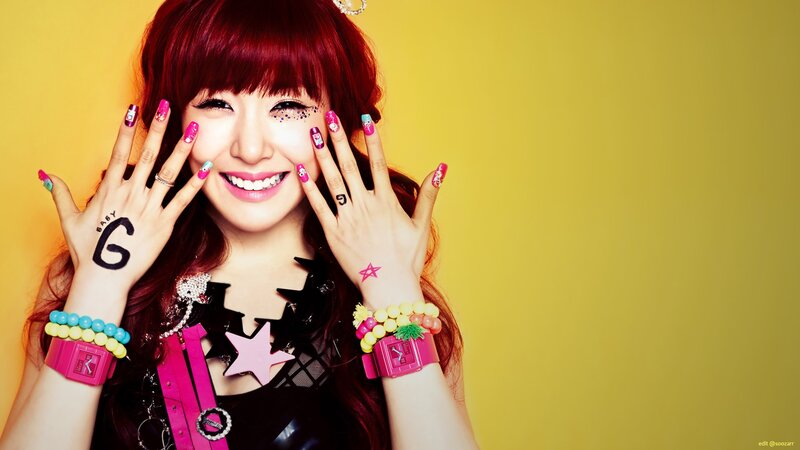 woman with red hair and colorful nails