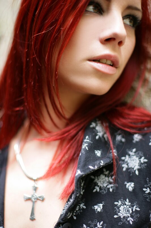 woman with red hair and cross necklace