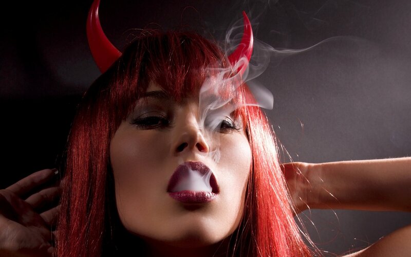 woman with red hair and devil horns