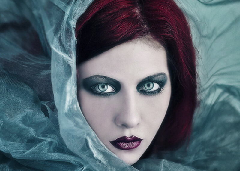 woman with red hair and dramatic makeup