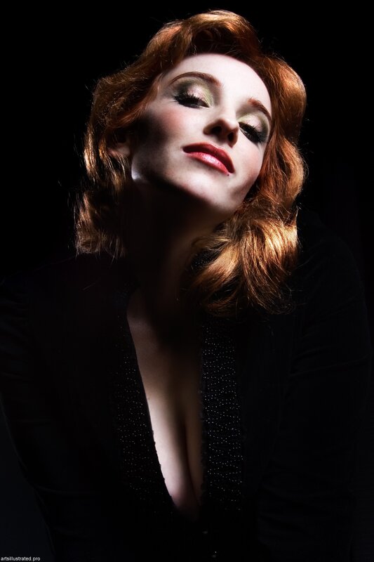 woman with red hair and dramatic makeup