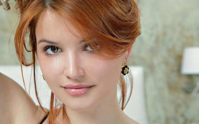 woman with red hair and earrings