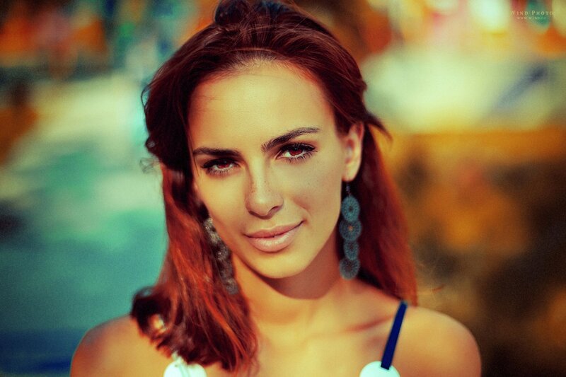 woman with red hair and earrings