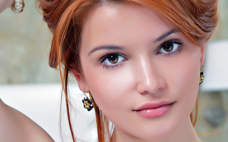 woman with red hair and earrings