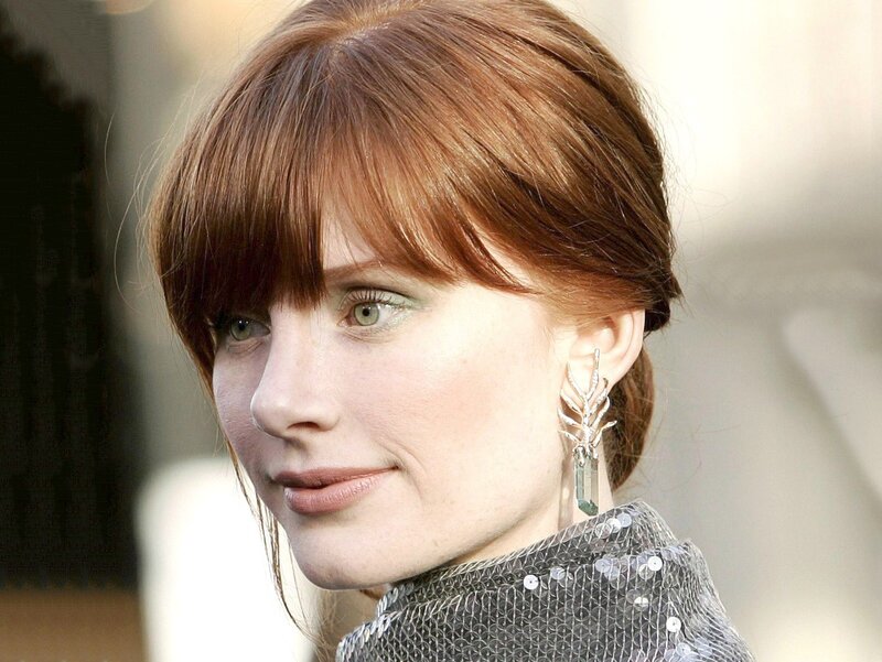 woman with red hair and earrings