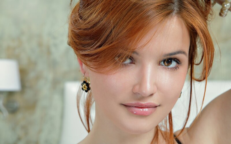woman with red hair and earrings