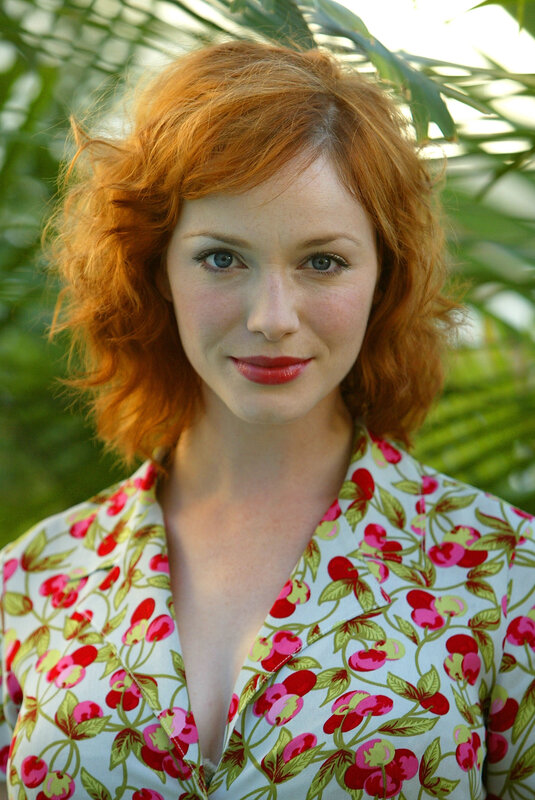 woman with red hair and floral shirt